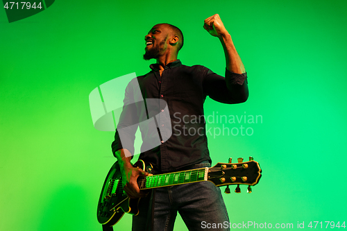 Image of Young african-american jazz musician playing the guitar