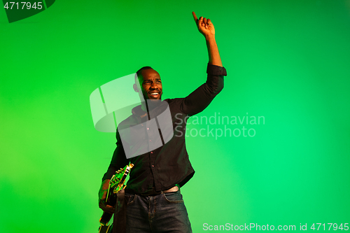 Image of Young african-american jazz musician playing the guitar