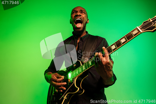 Image of Young african-american jazz musician playing the guitar