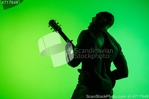 Image of Young african-american jazz musician playing the guitar