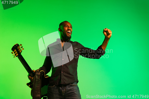 Image of Young african-american jazz musician playing the guitar