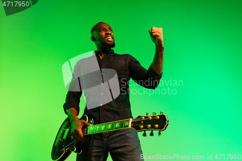 Image of Young african-american jazz musician playing the guitar
