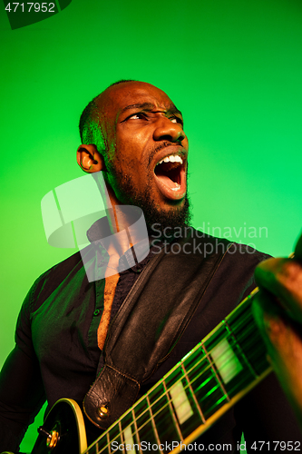 Image of Young african-american jazz musician playing the guitar