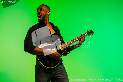 Image of Young african-american jazz musician playing the guitar