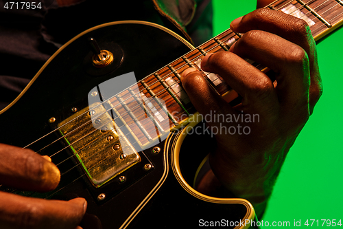 Image of Young african-american jazz musician playing the guitar