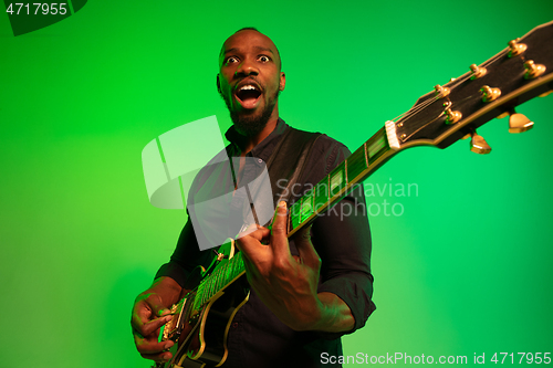 Image of Young african-american jazz musician playing the guitar