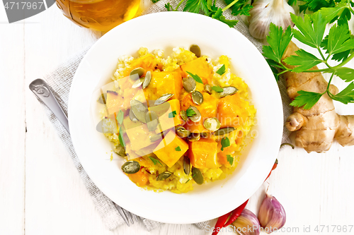 Image of Porridge millet with spicy pumpkin in plate on board top