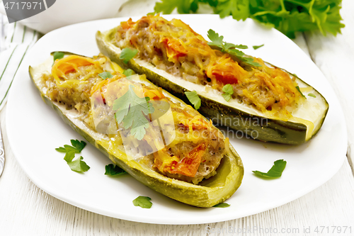 Image of Cucumber stuffed with meat and vegetables on light board