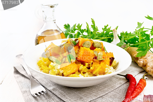 Image of Porridge millet with spicy pumpkin in plate on white board