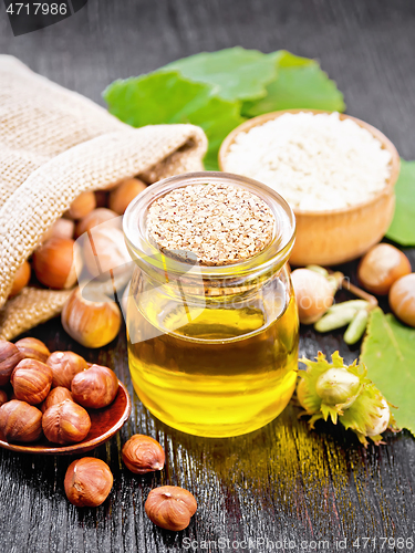 Image of Oil hazelnut in jar on board