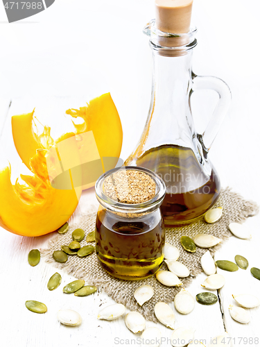 Image of Oil pumpkin in jar and carafe on light board