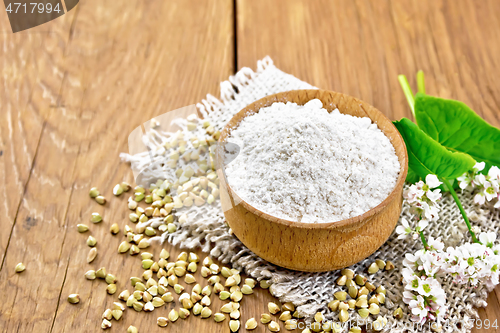 Image of Flour buckwheat green in bowl with flowers and leaves on board