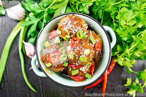 Image of Meatballs in sweet and sour sauce on board top