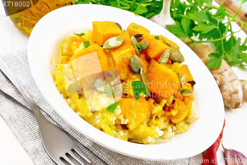 Image of Porridge millet with spicy pumpkin in plate on light board