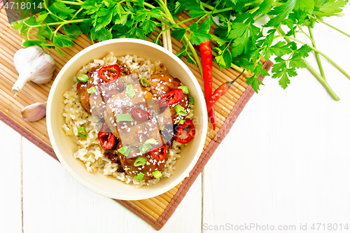 Image of Meatballs in sweet and sour sauce with rice on light board top