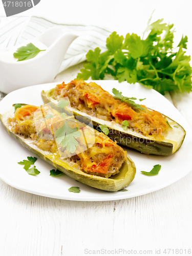 Image of Cucumber stuffed with meat and vegetables on white board