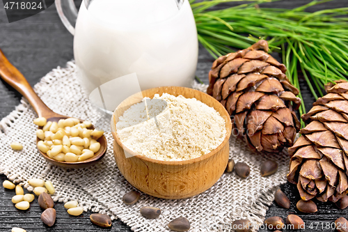 Image of Flour cedar in bowl with nuts on dark board
