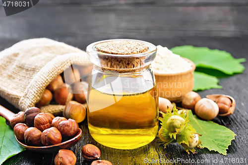 Image of Oil hazelnut in jar on wooden board