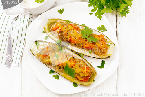 Image of Cucumber stuffed with meat and vegetables on light board top