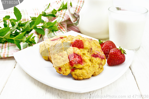 Image of Scones with strawberry in plate on white board