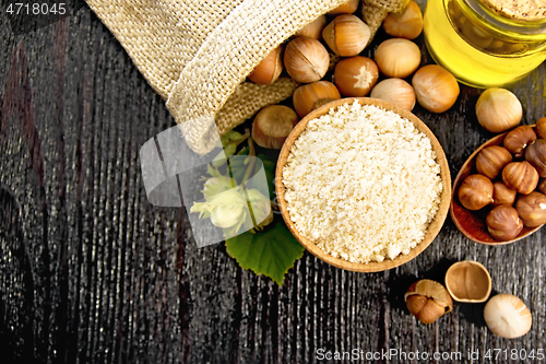 Image of Flour in bowl with nuts on board top