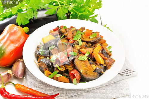 Image of Ragout with eggplant and pepper on wooden board