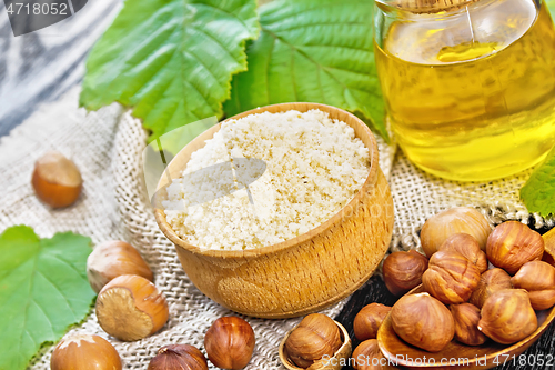 Image of Flour in bowl with oil on wooden board