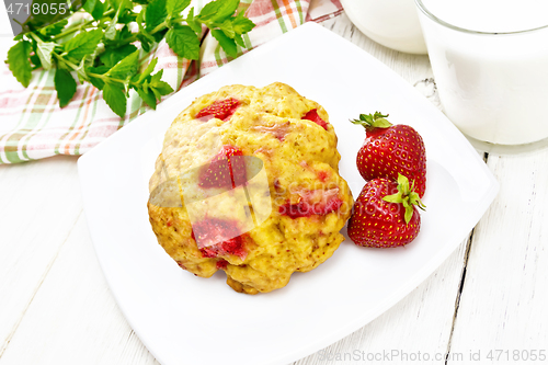 Image of Scones with strawberry in plate on light wooden board