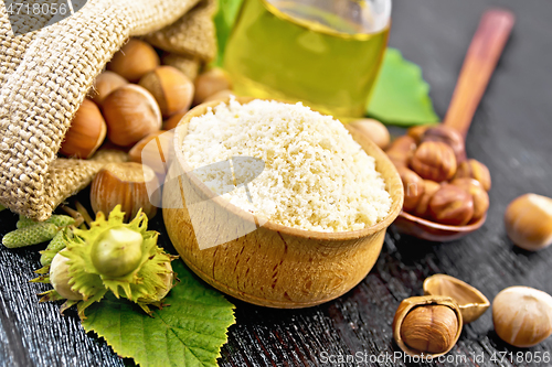 Image of Flour in bowl with nuts on board