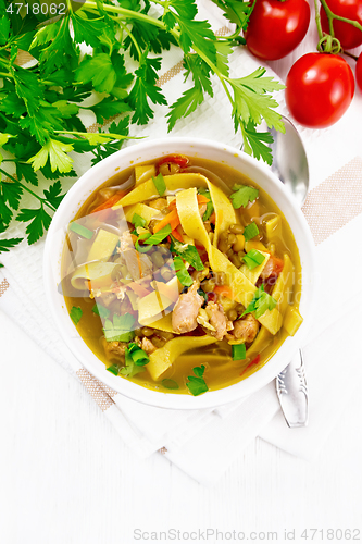 Image of Soup with mung and noodles in bowl on board top