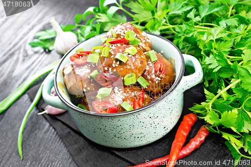 Image of Meatballs in sweet and sour sauce on board