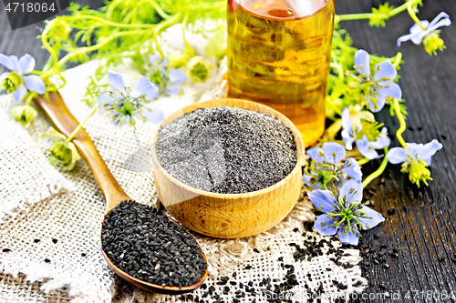 Image of Flour kalingi in bowl with seeds on dark wooden board