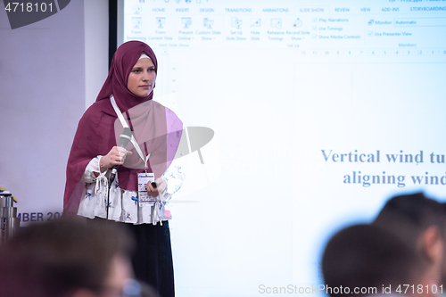 Image of Muslim businesswoman giving presentations at conference room