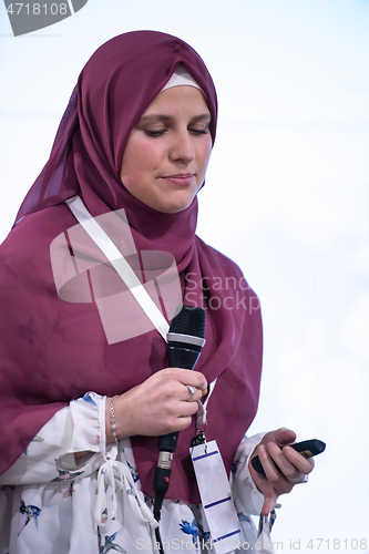 Image of Muslim businesswoman giving presentations at conference room