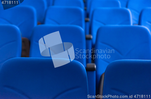 Image of hall with rows of blue seats