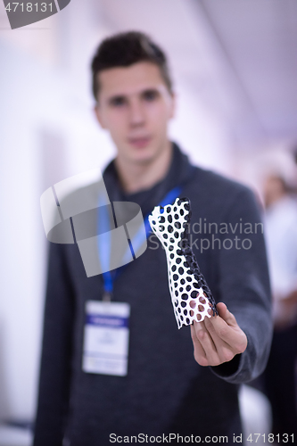 Image of young engineer showing 3D printed model