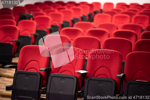 Image of hall with rows of red seats