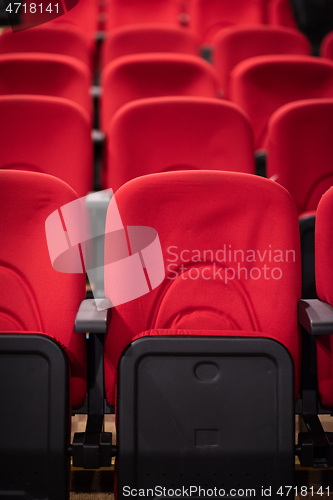 Image of hall with rows of red seats