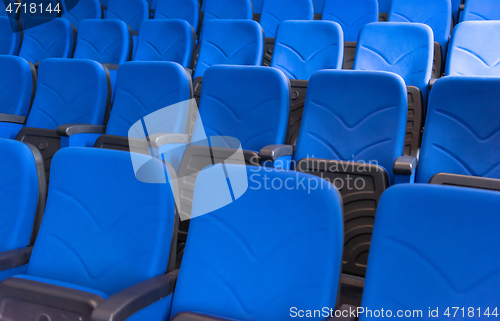 Image of hall with rows of blue seats