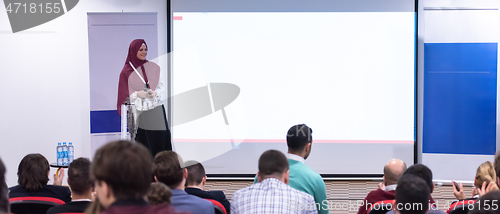 Image of Muslim businesswoman giving presentations at conference room