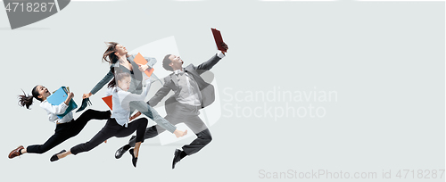 Image of Office workers jumping isolated on studio background