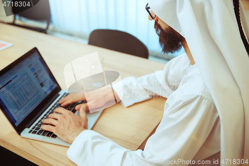 Image of Arabian saudi businessman working in office