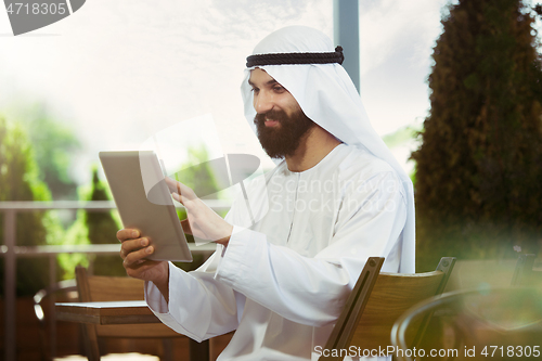 Image of Arabian saudi businessman working outdoors