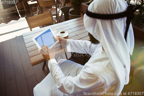 Image of Arabian saudi businessman working outdoors