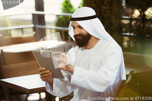 Image of Arabian saudi businessman working outdoors