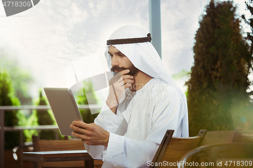 Image of Arabian saudi businessman working outdoors