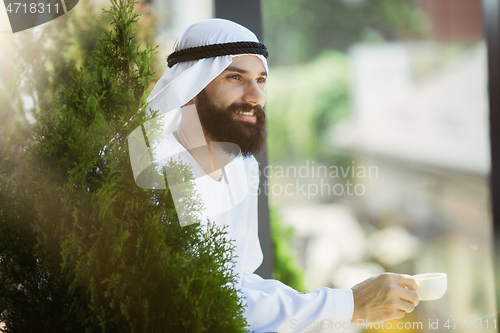 Image of Arabian saudi businessman working outdoors