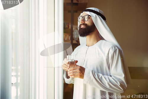 Image of Arabian saudi businessman working in office