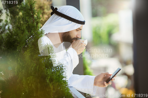 Image of Arabian saudi businessman working outdoors