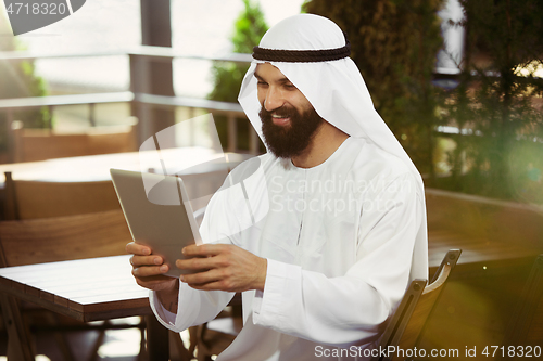 Image of Arabian saudi businessman working outdoors